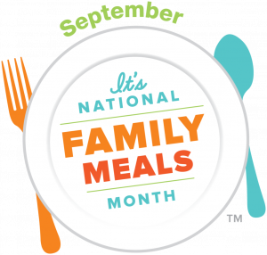 A plate with the text "It's National Family Meals Month" in the center, "September" above, and an orange fork and blue spoon on either side.